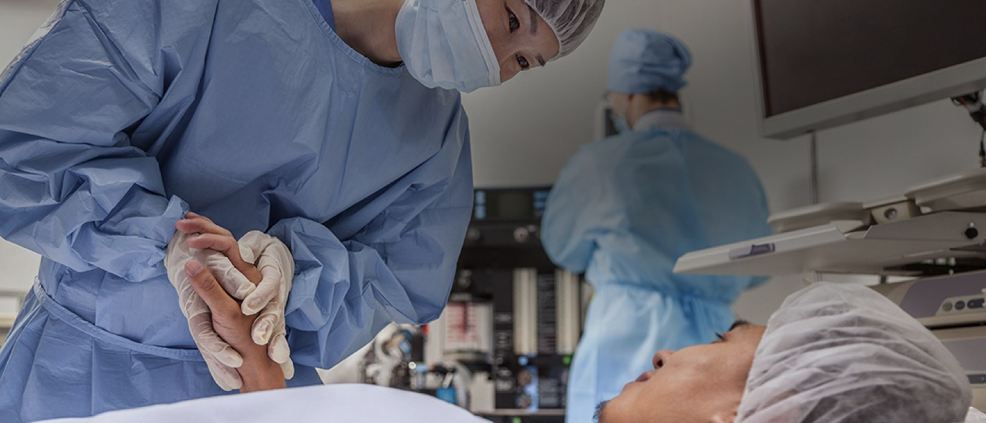 a group of people in blue lab coats and masks