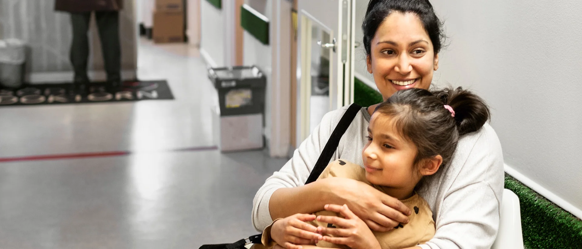A woman is holding a child in her arms