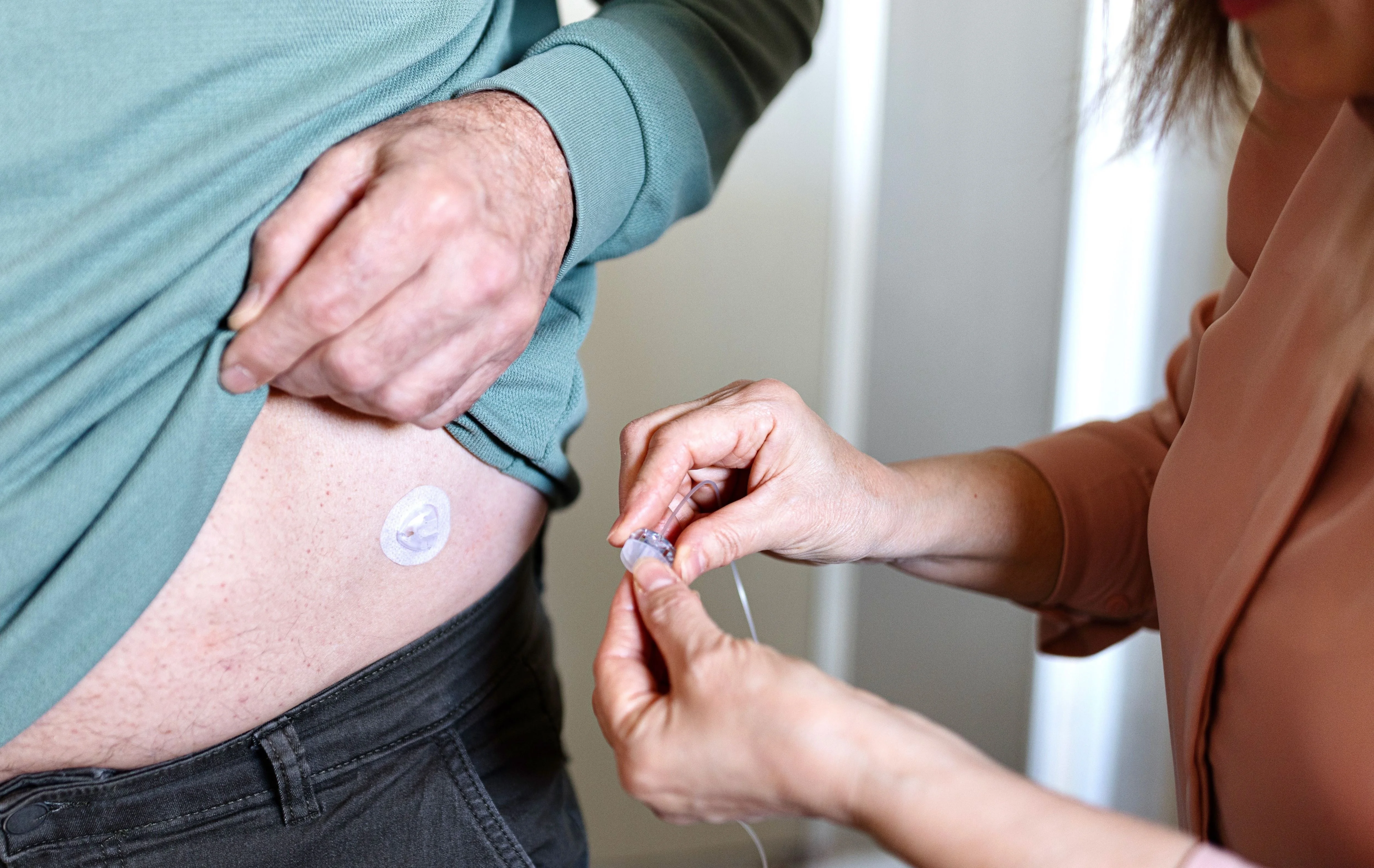 a person holding a needle to a person's hand