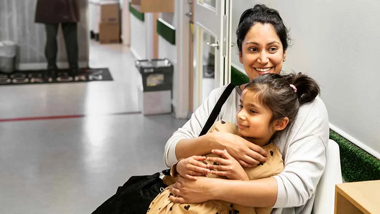 Una donna tiene un bambino tra le braccia